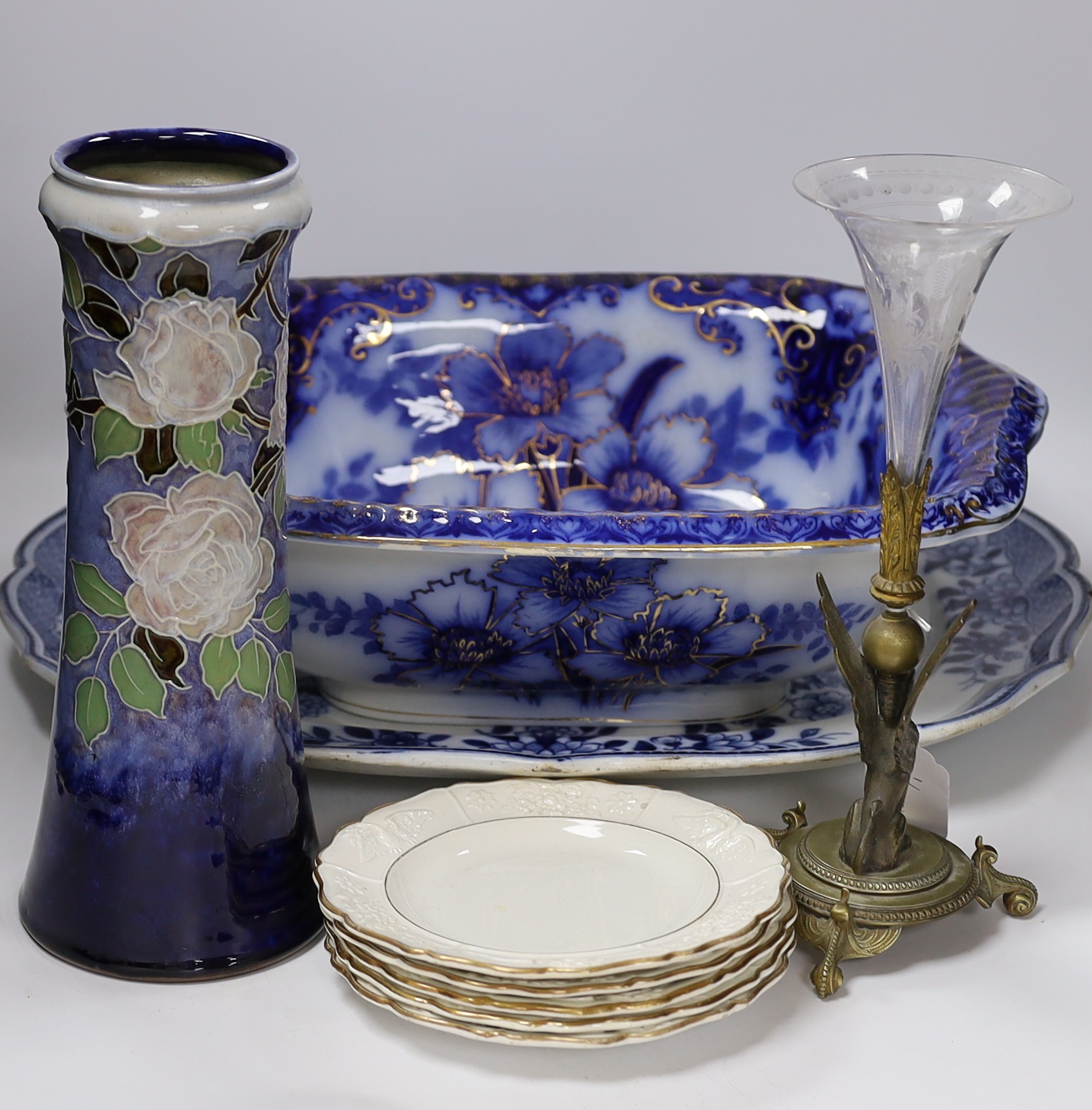 A Flow blue and gilt decorated bowl, a blue and white meat platter, a Royal Doulton vase, a gilt Egyptian inspired centrepiece and set of six gilt bordered plates